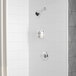 A white shower with a Delta shower head and hand shower on the wall.