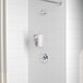 A white Delta shower with a shower head and hand held shower head.
