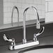 A chrome Delta deck-mount lavatory faucet with two handles on a counter.