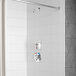 A Delta shower with a thermostat and a shower head.