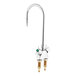 A silver Delta laboratory faucet with green handles.
