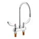 A chrome Delta deck-mount lavatory faucet with two wrist blade handles and gooseneck spout.