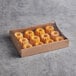 A box of New Day Mini Lemon Bundt Cakes on a table.