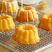 A cooling rack with New Day Mini Lemon Bundt Cakes.