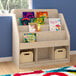 A wooden Flash Furniture book display shelf with books on it and storage baskets.