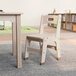 A Flash Furniture wooden classroom chair in a room.