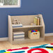 A wooden shelf with a variety of books and toys on it.