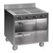 A Spring USA stainless steel mobile induction cooking cart with 4 ranges.