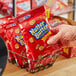 A hand holding a bag of Nabisco Nutter Butter Cookie Bites.