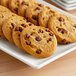 A plate of Nabisco Chips Ahoy! Chewy Chocolate Chip cookies with chocolate chips.