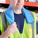 A man wearing a reflective vest and a blue Lavex cooling towel.