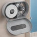 A Lavex VersaHub gray double roll jumbo toilet paper dispenser on a wall.