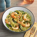 A bowl of pasta with Beleaf Plant-Based Vegan jumbo shrimp and vegetables.