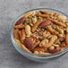 A bowl of Albanese Party Snack Mix on a table.