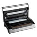 A black and silver Galaxy vacuum packaging machine with a white tube and roll holder.