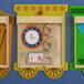 A Flash Furniture wooden wall activity board with three wooden train clocks.