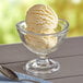 A bowl of I. Rice Cake Batter ice cream with a spoon on the side.