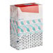 A close-up of a stack of Puffs tissue boxes with different designs.