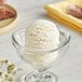 A bowl of I. Rice coconut hard serve ice cream base with a spoon in it.
