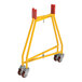 A yellow metal Vestil bucket dolly with red wheels.