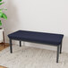 A navy Lesro Lenox 2-seat bench with a blue cushion on top.