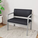 A black and grey Lesro Lenox Steel Patriot Plus bariatric guest chair with black vinyl seating.