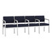 A Lesro Lenox navy blue sofa with white frame and navy cushions.