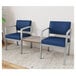 Two Lesro Lenox blue vinyl arm chairs with a Sarum Twill laminate table connecting them.