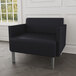 A Lesro Luxe Lounge Series black vinyl bariatric guest arm chair in a lounge area.