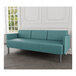 A Lesro Luxe Lounge Series Patriot Plus Sea Vinyl 3-Seat Sofa with steel legs in a room with a white wall.