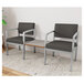 Two grey Lesro Lenox guest chairs with a Sarum Twill laminate table in between them.