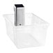 A clear plastic container with a silver VacPak-It sous vide immersion circulator head inside.