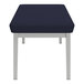 A Lesro Lenox steel bench with navy blue cushions.