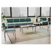 A blue Lesro Lenox steel bench with sea vinyl seat cushions in a lounge area.