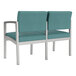 A Lesro Lenox steel loveseat with blue sea vinyl and metal legs.