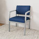 A blue and silver Lesro Lenox guest chair with arms.