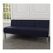 A navy blue Lesro Luxe Lounge Series 3-seat sofa with steel legs in a lounge area.