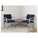 Two navy Lesro Lenox armchairs with a corner table in a lounge area.