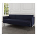 A Lesro Luxe Lounge navy blue sofa with metal legs in a room with a white wall.