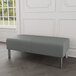 A Lesro Luxe Lounge grey fabric bench with steel legs.
