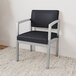 A Lesro Lenox black guest chair with black cushion.