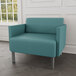 A Lesro Luxe Lounge Patriot Plus bariatric arm chair with steel legs upholstered in teal blue vinyl.