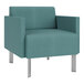 A teal Lesro Luxe Lounge arm chair with chrome legs.