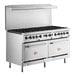 A stainless steel Cooking Performance Group commercial gas range with two convection ovens.