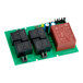 A green Estella SC control board with black and red rectangular objects.