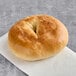 A Just Bagels plain bagel on a counter.