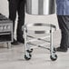 A Vigor stainless steel stock pot on a metal dolly with black wheels.