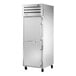 A True white reach-in freezer with silver handles and wheels.