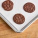 A tray of chocolate chip cookies baked on a Baker's Lane parchment paper-lined sheet.