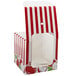 A red and white striped Baker's Lane candy apple box with apples on it.